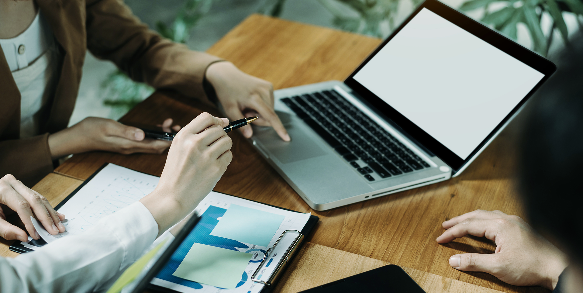 Person working on laptop with travel documents